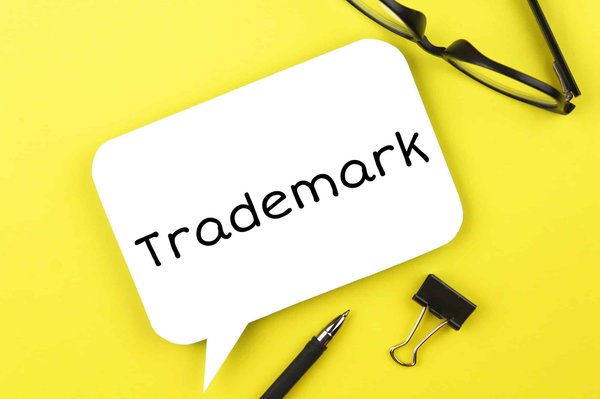 What are the specific steps to register a trademark in the UK for a new product line?